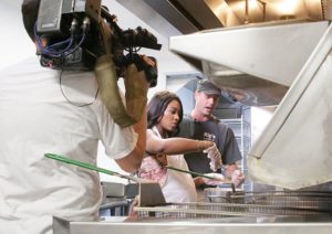 NewsTribune Photo/Scott Anderson Brittney Payton begins to deep fry chicken with the help of Jeff Rounds in the kitchen at Rip's Tavern in Ladd Thursday afternoon. Payton is the daghter of the Chicago Bears famous running back Walter Payton.